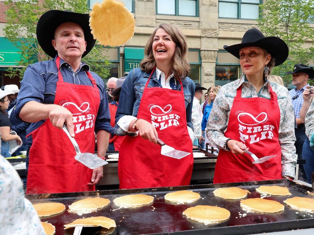  federal minister of tourism randy boissonnault, premier danielle smith and mayor jyoti gondek flip the flapjacks in the first flip pancake breakfast on stephen avenue mall.