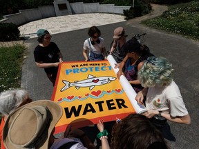 Protestors roll up a banner following a rally to raise concerns and opposition to the Ontario provincial government's plans to expand mining operations in the so-called Ring of Fire region in Northern Ontario, in Toronto, Thursday, July 20, 2023.