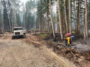 Firefighters and heavy equipment crews work to control lines on the southeast side of the Basset fire (HWF058) on July 2, 2023.