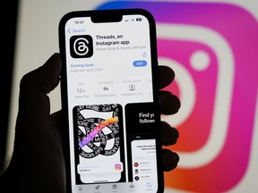 The Threads app, operated by Meta Platforms Inc., on a smartphone, beside an Instagram logo.