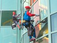 Superhero Grime Fighters Mario and Spiderman wash the windows at Alberta Children’s Hospital on Tuesday, July 25, 2023.