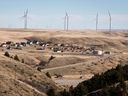 A wind farm overshadows a small subdivision near Pincher Creek, Alta.