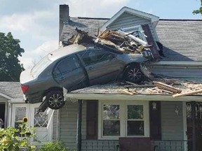 A car launched into the air and landed in a second-floor bedroom of a Pennsylvania home, where it remained dangling on Sunday afternoon.
