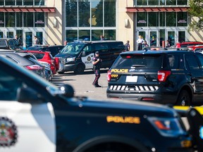 Calgary police contain the scene of a shooting in the parking lot outside the south entrance of Market Mall on Saturday, August 12, 2023.