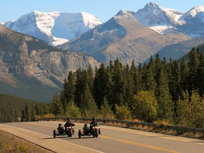 An image of two motorcycles traveling along the Icefields Parkway in Jasper National Park, Alberta, Canada.