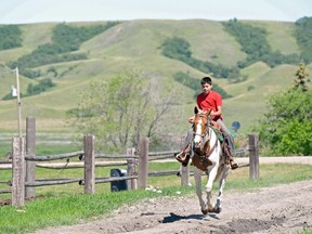 A child rides a horse at Muscowpetung Saulteaux First Nation in Saskatchewan.