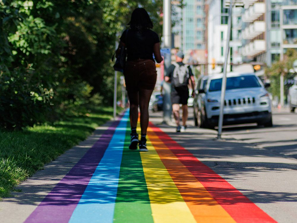 The newly painted rainbow sidewalk next to Central Memorial Park in Calgary's Beltline.