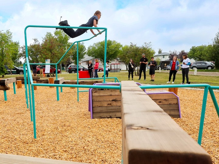 Naomi Babstock swings around at the new Coventry Hills Parkour Park on Wednesday.