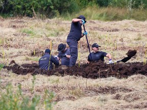 Calgary police forensics officers dig in a field beside Highway 762 southwest of Calgary as part of an investigation on Wednesday, August 30, 2023.