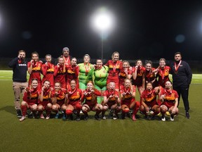 Members of the University of Calgary Dinos women's soccer team celebrate after capturing the bronze medal during the Canada West championship at Thunderbird Stadium in Vancouver on Saturday, Nov. 5, 2022. (Andrew Lee/UBC Thunderbirds)