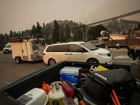 For Canadians facing a short-term loss of income, whether it be from wildfire evacuations or other reasons, financial experts say there are differences in how they should navigate a short-term disruption in pay compared with a longer-term income loss. Evacuees leave with a trailer of belongings after a wildfire evacuation alert was upgraded to an order and they were forced to leave the Wilden neighbourhood near Knox Mountain, in Kelowna, B.C., Friday, Aug. 18, 2023.