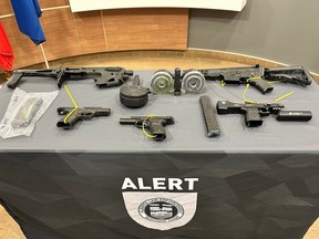 Two men face a slew of charges after officers with the province's elite ALERT guns and drugs unit seized firearms, ammo and prohibited items including extended magazines and a silencer after executing search warrants on addresses and vehicles in St. Albert on Aug. 2, 2023.