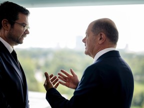 German Chancellor Olaf Scholz, right, speaks with German Justice Minister Marco Buschmann during the cabinet meeting of the German government at the chancellery in Berlin, Germany, Wednesday, Aug. 23, 2023.