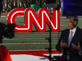 FILE - A journalist records video near a CNN sign on an athletic field outside the Clements Recreation Center where the CNN/New York Times will host the Democratic presidential primary debate at Otterbein University, Monday, Oct. 14, 2019, in Westerville, Ohio. Mark Thompson was appointed as chair and CEO of CNN by David Zaslav, head of the network's parent company, Warner Bros. Discovery, which made the announcement Wednesday, Aug. 30, 2023. Thompson replaces Chris Licht, who was fired in June, and a four-person team that had been running CNN in the interim.