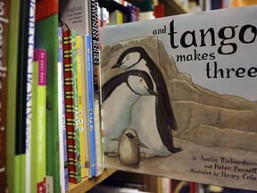 FILE - A copy of the book "And Tango Makes Three" is photographed on a bookstore shelf in Chicago, Nov. 16, 2006. Months after access to the popular children's book about a male penguin couple hatching a chick was restricted at school libraries because of Florida's so-called "Don't Say Gay" law, a central Florida school district says it has reversed that decision. The complaint challenged the restrictions and Florida's new law prohibiting classroom discussion about sexual orientation or gender identity in certain grade levels.