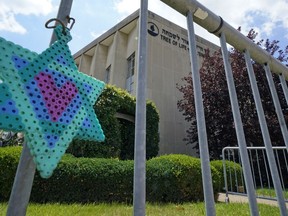 A Star of David hangs from a fence outside the dormant landmark Tree of Life synagogue in Pittsburgh's Squirrel Hill neighborhood on Thursday, July 13, 2023, the day a federal jury announced they had found Robert Bowers, who in 2018 killed 11 people at the synagogue, eligible for the death penalty.