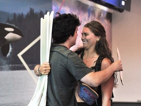 Bennet Brule greets Madeleine Platt after she arrives at Vancouver International Airport on Thursday.