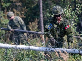 Canadian Armed Forces soldiers construct a firebreak in Parker Recreation Field in Yellowknife to help fight wildfires on Wednesday, Aug.16, 2023.
