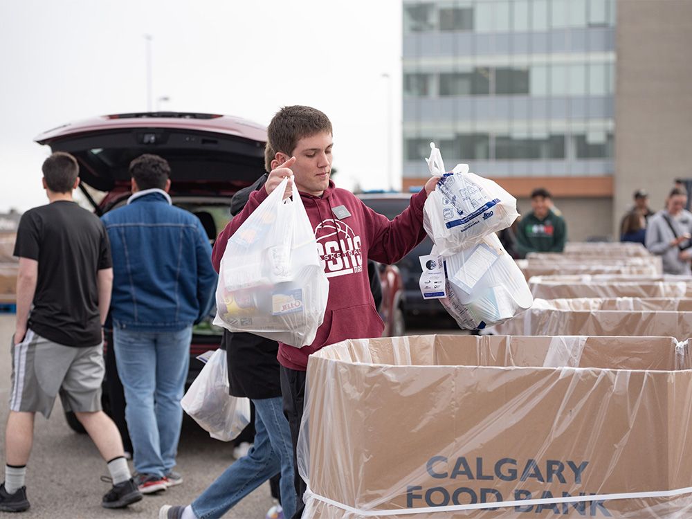 Volunteers help sort the donated items collected in the Citywide Food Drive at the parking lot of Westbrook Mall on Saturday, September 23, 2023.