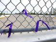 Ribbons tied to a chain-link fence