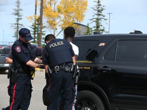 Calgary police take a man into custody in relation to a gun incident at the Calgary airport