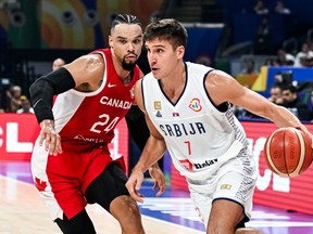Serbia's Bogdan Bogdanovic (R) blows past Canada's Dillon Brooks during the FIBA Basketball World Cup semi-final match between Serbia and Canada in Manila on September 8, 2023. (Photo by SHERWIN VARDELEON/AFP via Getty Images)