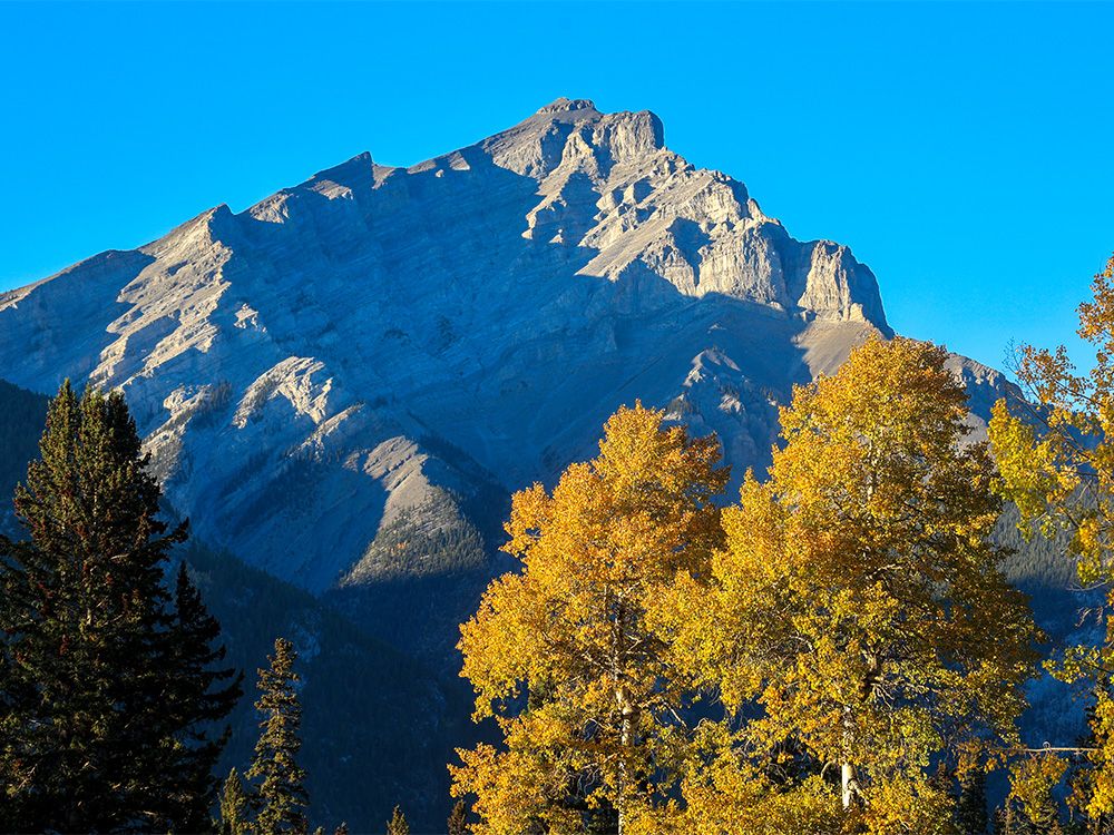 Fall colours frame Cascade Mountain near Banff on Thursday, September 21, 2023.