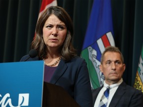 Premier Danielle Smith answers media questions as Dr. Mark Joffe, chief medical officer of health, listens in the background