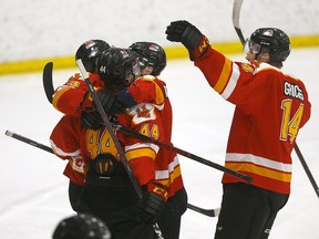 The Calgary Dinos celebrate a goal against the Alberta Golden Bears during the Canada West men’s hockey championship at Father David Bauer Arena in Calgary on March 3, 2023.