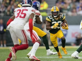 FILE - Green Bay Packers running back Aaron Jones (33) carries the ball during the second half of an NFL football game against the New York Giants at the Tottenham Hotspur stadium in London, on Oct. 9, 2022. The NFL will continue staging at least two games per year at Tottenham Hotspur Stadium through the 2029 season, it announced Thursday, Sept. 14, 2023.