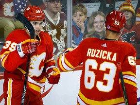 Calgary Flames forward Matt Coronato celebrates a goal against the Vancouver Canucks with Adam Ruzicka during pre-season action at Scotiabank Saddledome in Calgary on Sunday, Sept. 24, 2023.