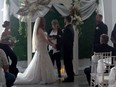 Sarah and Dave Roy are seen during their wedding in a still image made from video shot at the Garcelon Civic Centre in St. Stephen, N.B., Saturday, Sept. 16, 2023.