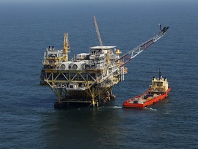 FILE - A rig and supply vessel are pictured in the Gulf of Mexico off the cost of Louisiana, April 10, 2011. A federal judge has ordered the Interior Department to expand next week's scheduled sale of Gulf of Mexico oil and gas leases by millions of acres. The Thursday, Sept. 22, 2023, ruling rejected a scaled-back plan announced last month by the Biden administration as part of an effort to protect an endangered whale species.