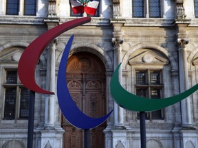 FILE - The logo of the Paris 2024 Paralympic Games is pictured in front of the Paris town hall, France, Friday, Nov. 10, 2017. Votes are taking place Friday, Sept 29, 2023, on whether to "partially suspend" Russia from the International Paralympic Committee. That could mean Russia sends competitors to the Paralympics in Paris next year but that they have to compete as neutral athletes without national symbols.