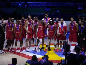 Canada players pose for a photo after the Basketball World Cup bronze medal game between the United States and Canada in Manila, Philippines, Sunday, Sept. 10, 2023.