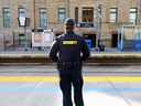 Security stands on the platform of a downtown CTrain station on Monday, October 2, 2023.
