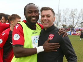 Cavalry FC Bradley Kamdem Fewo (L) and Nik Ledgerwood celebrate a victory during CPL playoff soccer action on ATCO Field at Spruce Meadows in Calgary on Saturday, October 21, 2023