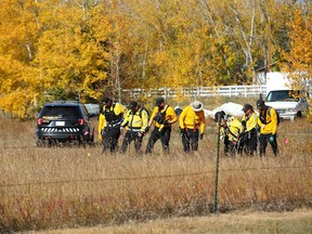 Calgary Search and Rescue teams and Calgary police are shown at a residence east of Chestermere