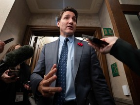Prime Minister Justin Trudeau speaks with reporters on his way to the House of Commons, in Ottawa, Tuesday, Oct. 31, 2023.
