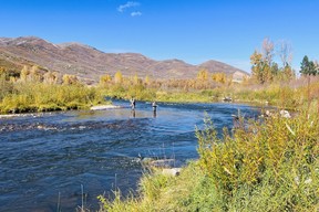 An image of two fly fishermen on the Middle Provo River in Utah, USA.