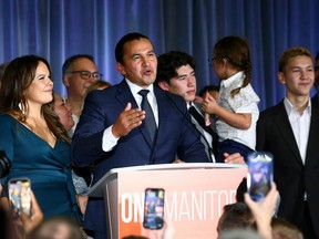 Surrounded by family, Wab Kinew gives his victory speech at NDP provincial election night headquarters at the Hotel Fort Garry in Winnipeg on Tues., Oct. 3, 2023.