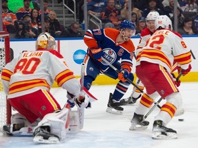 Connor McDavid (97) of the Edmonton Oilers, looks for a play in front of goalie Dan Vladar of the Calgary Flames at Rogers Place in Edmonton on Oct. 4, 2023. The first period ended at 2-2. Photo by Shaughn Butts-Postmedia