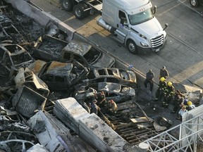 Responders are seen near wreckage in the aftermath of a multi-vehicle pileup on I-55 in Manchac, La., Monday, Oct. 23.