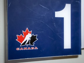 A Hockey Canada logo is seen on the door to a dressing room the organizations home rink in Calgary, Alta., Sunday, Nov. 6, 2022. Hockey Canada has implemented a new dressing room policy for the 2023-24 minor hockey season, including a "minimum attire rule," with the goal of respecting privacy and making dressing environments more inclusive.