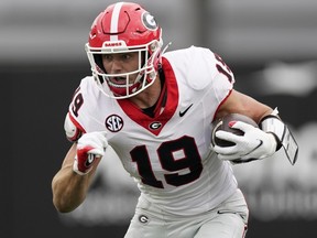 FILE - Georgia tight end Brock Bowers (19) runs the ball after a catch against Vanderbilt in the first half of an NCAA college football game Saturday, Oct. 14, 2023, in Nashville, Tenn. Bowers has been selected to The Associated Press midseason All-America team, Wednesday, Oct. 18, 2023.