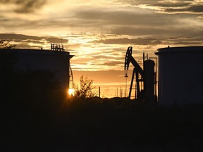 Crude oil tanks and a pumpjack in Midland, Texas.