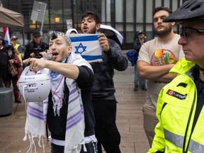 Israeli supporters yell at Palestinian supporters rallying at Vancouver Art Gallery in Vancouver, B.C., October 9, 2023.