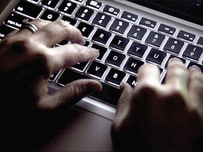 A woman uses her computer keyboard to type