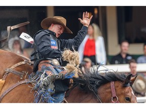 Zeke Thurston from Big Valley, Alberta riding Urgent Delivery wins the Saddle Bronc event of the third day of Calgary Stampede rodeo at Grandstand on Sunday, July 10, 2022. Azin Ghaffari/Postmedia