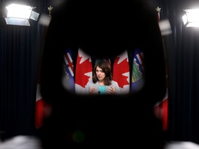 Alberta Premier Danielle Smith is framed by a camera stand as she outlines an initiative to accelerate carbon capture in the province during a news conference at the Alberta legislature on Tuesday, Nov. 28, 2023.